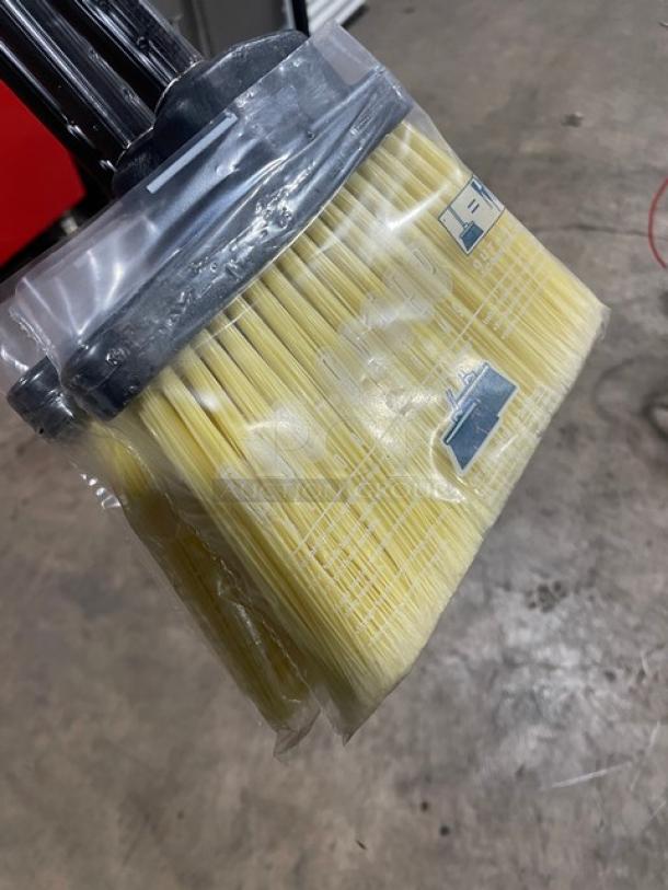 New commercial floor broom with black grip handle, sealed bristles. Durable and ideal for heavy-duty use.