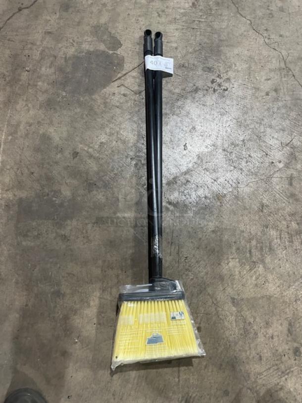 New commercial floor broom with black grip handle. Includes two brooms per bid. Yellow bristles, unused condition.