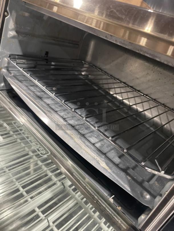 BLACK+DECKER stainless steel convection toaster oven, model TO3250XSB, featuring extra-wide interior and wire rack.