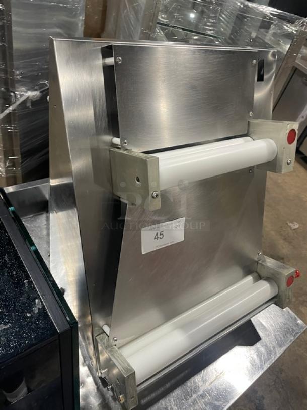 Commercial stainless steel electric countertop dough sheeter in excellent condition, featuring dual rollers and control buttons.