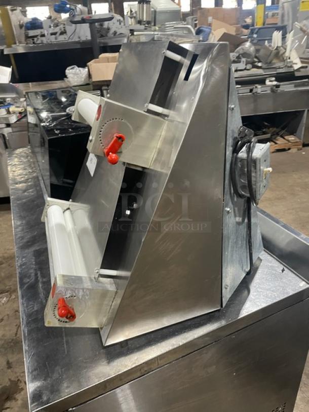 Commercial stainless steel electric countertop dough sheeter, features adjustable rollers, red control knobs, used condition.