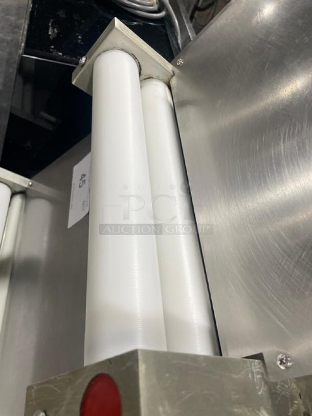 Commercial stainless steel electric countertop dough sheeter, features durable construction and efficient rolling mechanism.