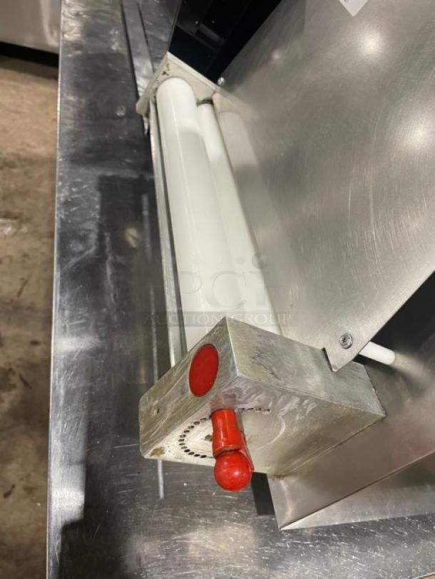 Commercial stainless steel electric countertop dough sheeter, featuring roller mechanism. Clean condition, suitable for bakery use.