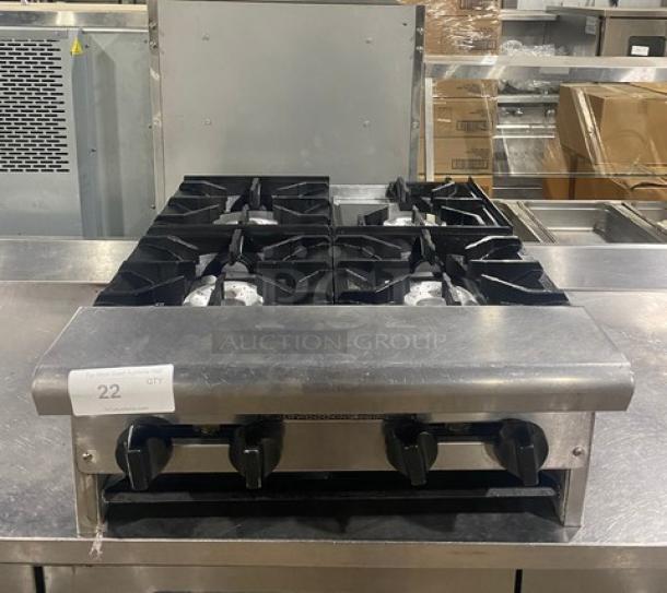 American Range stainless steel, natural gas 4-burner countertop range in good condition with control knobs and grate.