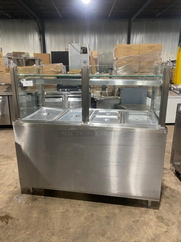 APW Wyott stainless steel electric 4-well hot food table with sneeze guard, on legs; suitable for commercial use.