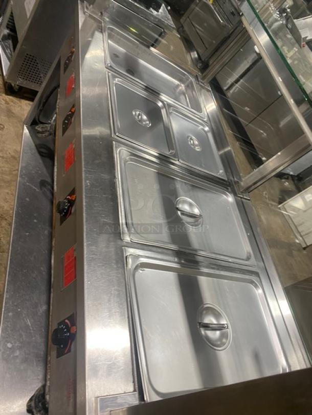 APW Wyott stainless steel 4-well hot food table with sneeze guard. Electric, on legs, visible control dials. Excellent condition.