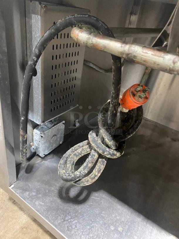 APW Wyott stainless steel electric 4-well hot food/steam table underside, shows power cable and connections.