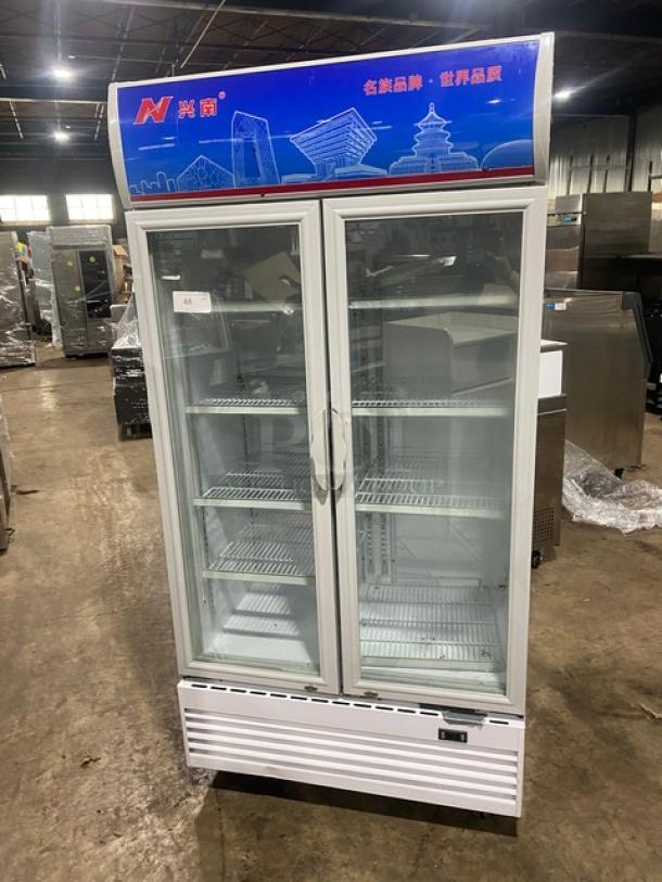 Commercial white double glass swing-door reach-in merchandiser refrigerator, model LG-800BF, with poly-coated wire racks, 220V.