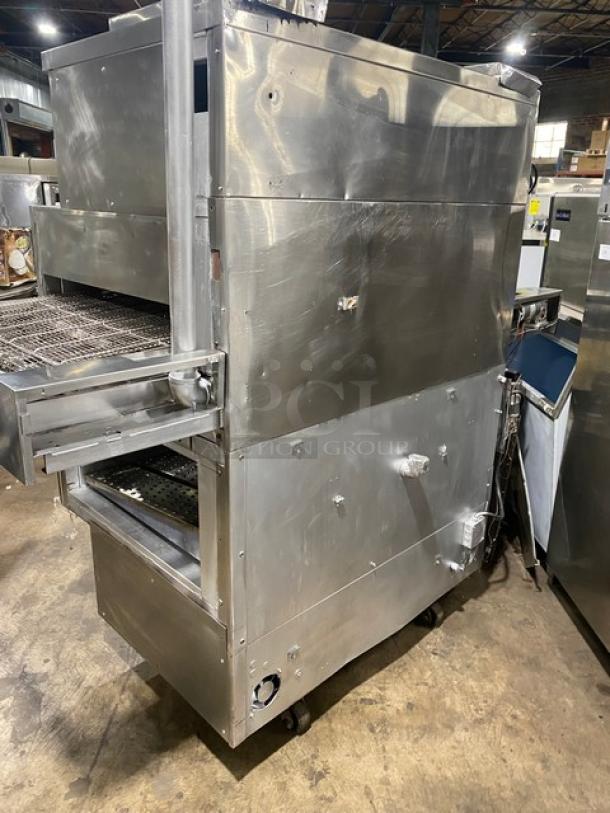 Middleby Marshall double-stacked stainless steel conveyor pizza oven on casters. Electric-powered, commercial-grade.