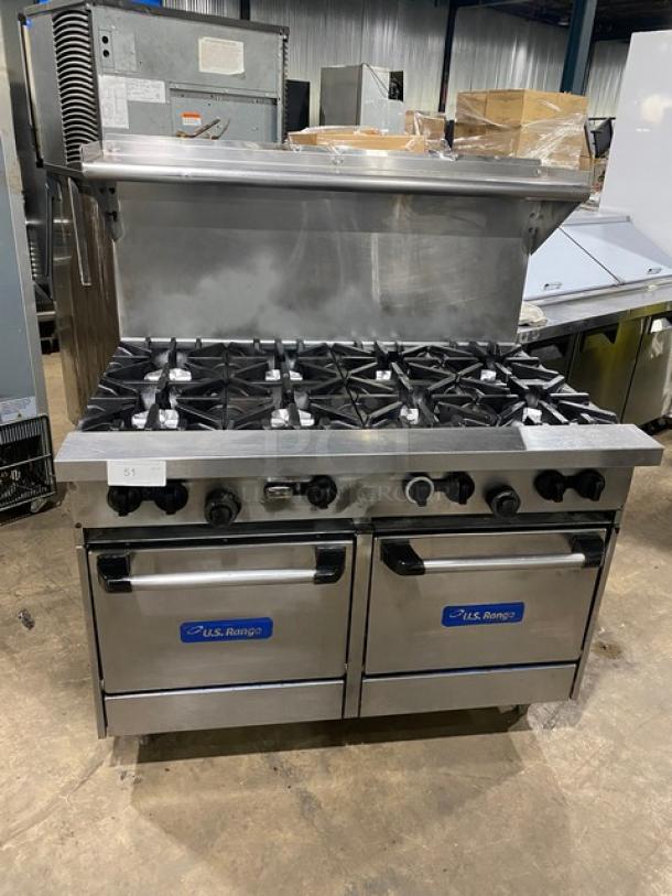 U.S. Range commercial stainless steel 8-burner range and double oven combo with backsplash, overhead salamander shelf, and wired oven racks.