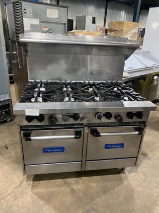 U.S. Range commercial stainless steel 8-burner range and double oven combo with backsplash, overhead salamander shelf, and wired oven racks.