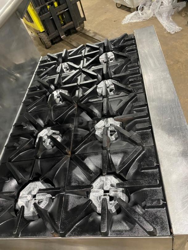U.S. Range 8-burner commercial stainless steel range with double oven, backsplash, and salamander shelf. Natural gas powered.