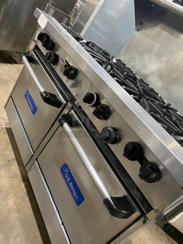 U.S. Range commercial stainless steel 8-burner range with double oven, backsplash, salamander shelf, and wired racks.