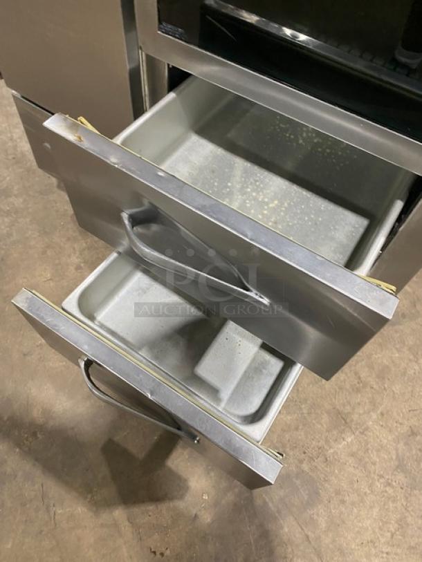 Traulsen stainless steel refrigerator/freezer combo, model URS36DT, with drawers open. Chrome-plated wire racks.