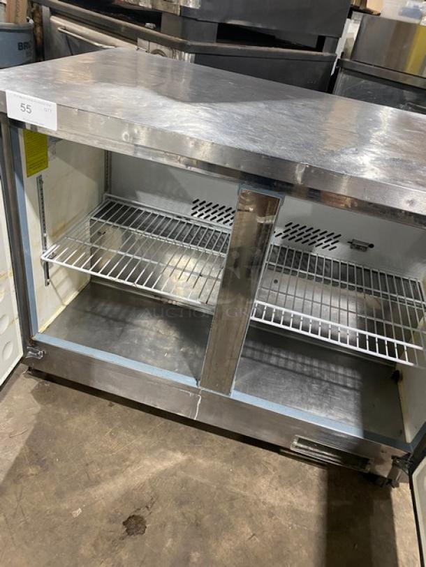 Entree UR48Q stainless steel 2-door undercounter refrigerator, Energy Star certified, with casters, clean interior.