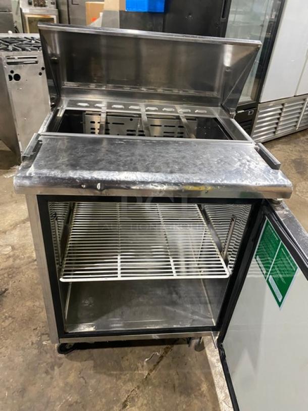Turbo Air TST-28SD stainless steel refrigerated prep table with poly-coated wire rack, on casters, in good condition.