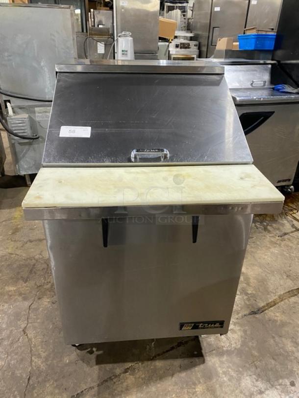 True stainless steel refrigerated prep table, model TSSU-27-12M-C, with cutting board, poly-coated wire rack, on casters.