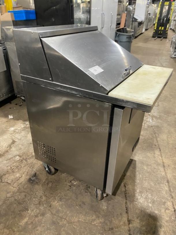 True stainless steel single door refrigerated prep table, TSSU-27-12M-C model with cutting board and poly-coated wire rack.