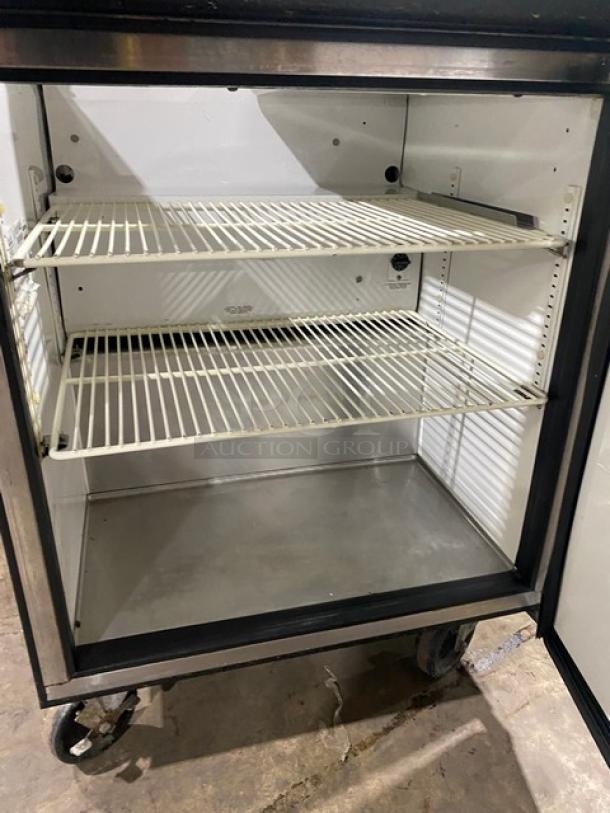 True TSSU-27-12M-C refrigerated prep table with stainless steel, single door, poly coated wire racks, on casters.