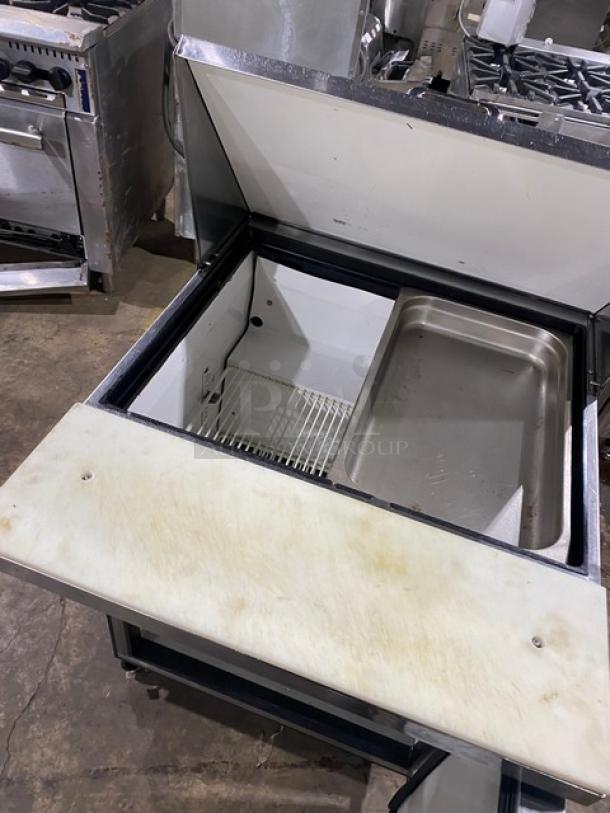 True TSSU-27-12M-C refrigerated prep table with cutting board, stainless steel, includes wire rack, on casters, 115V, single door.