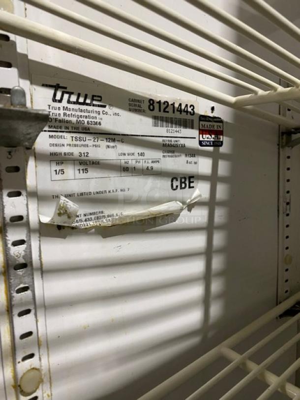 True TSSU-27-12M-C refrigerated prep table, single door, stainless steel, with poly coated wire rack. Model info visible.
