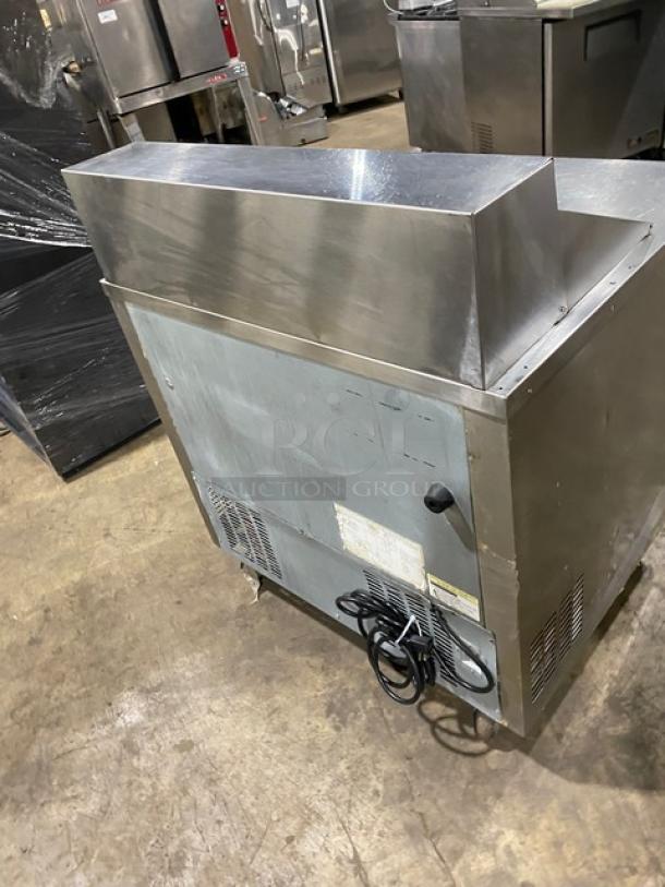 Everest stainless steel 2-drawer refrigerated prep table on casters. Visible wear on surface, power cord attached.