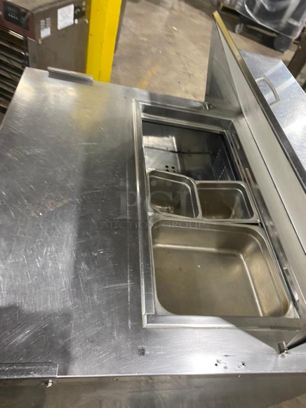 Everest stainless steel 2-drawer refrigerated prep table with top bins, on casters. Used condition, suitable for salad/sandwich prep.