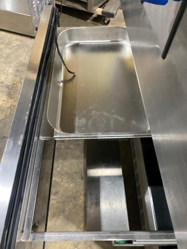 Everest stainless steel prep table with 2 refrigerated drawers, on casters. Shown open, highlighting storage space and durable construction.