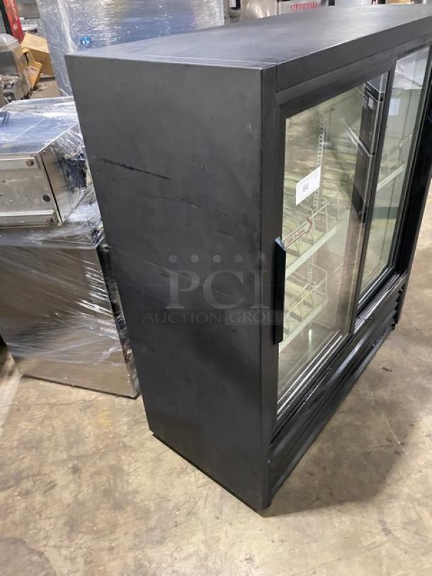 True GDM41SL54 black double glass sliding door merchandiser refrigerator with poly coated wire racks, in good condition.