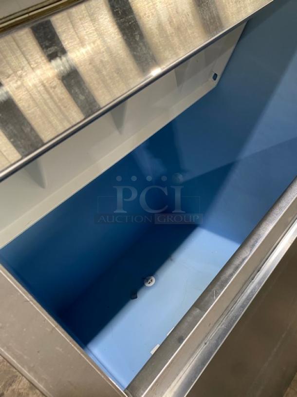 Hoshizaki stainless steel ice maker and storage bin combo, electric-powered, on legs, open lid showing clean interior.