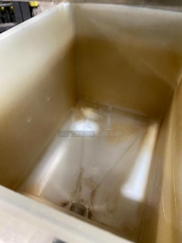 Interior view of a Bunn commercial coffee brewer, showing the stainless steel compartment. Clean, slightly used condition.