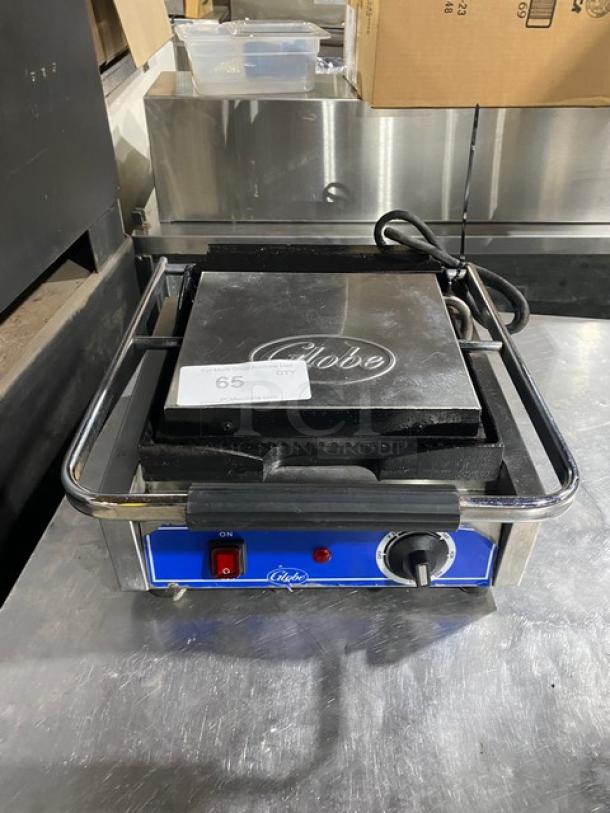 Globe Commercial Electric Panini Grill with grooved top and bottom grates, thermostatic control, 120V, on legs, good condition.