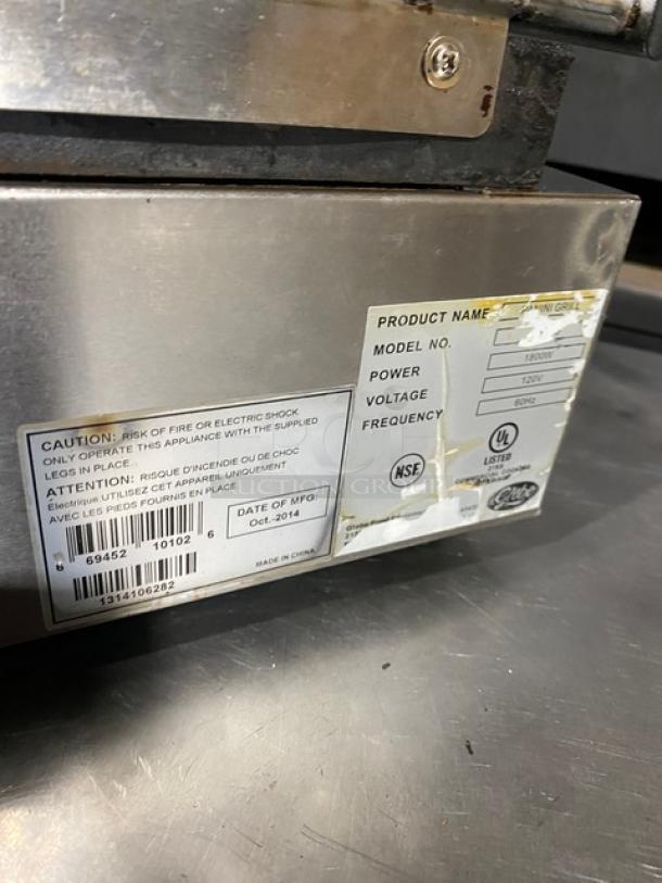 Globe stainless steel electric panini grill, grooved grates, thermostatic control, 120V, on legs, model label visible.