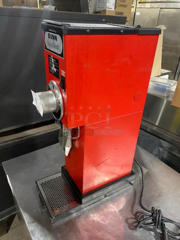 Bunn G3 red electric countertop bulk coffee grinder, 120V, 1 phase. Features a "Bunn" label and visible power cord.