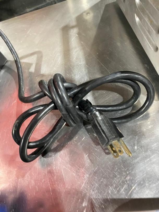 Bunn G3 commercial red electric coffee grinder power cord, 120V, 1 phase. Coiled cable on metal surface. Model SN: 8406.