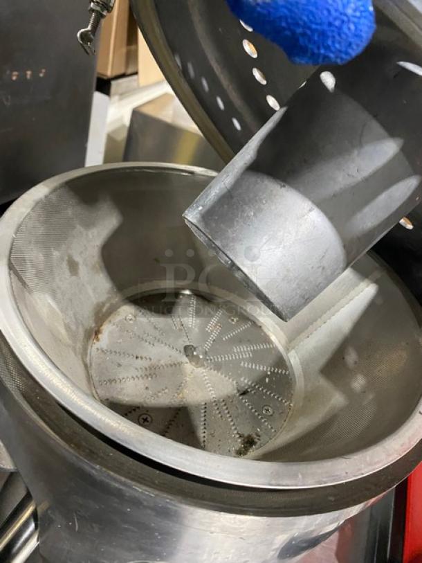 L&J stainless steel electric countertop juice extractor, model WF-A2000. Visible wear inside mesh basket.