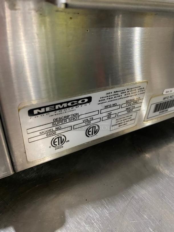 Nemco stainless steel Super Shot portion steamer, model 6600, SN: F22-2967, 120V, on legs, label showing specifications.