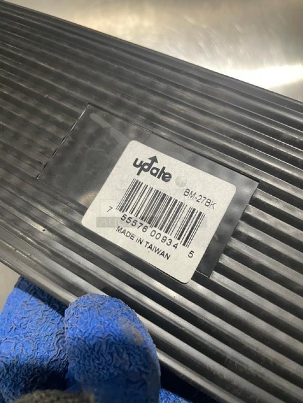 NEW Update International BM27BK black rubber bar mat, 27" length, commercial use, labeled with barcode and "Made in Taiwan."