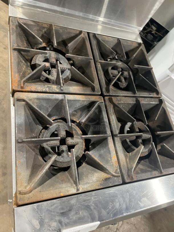 Cookline commercial stainless steel 4 burner range/oven combo with backsplash, overhead salamander shelf, and gas connection hose.