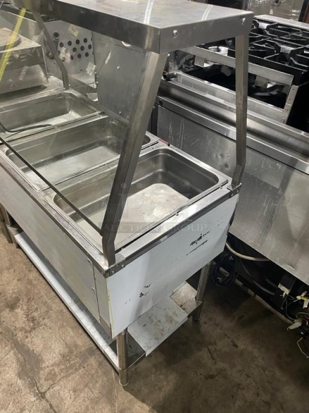 Serv-Ware stainless steel electric 3-well hot food table with sneeze guard and single undershelf, Model EST3-1.