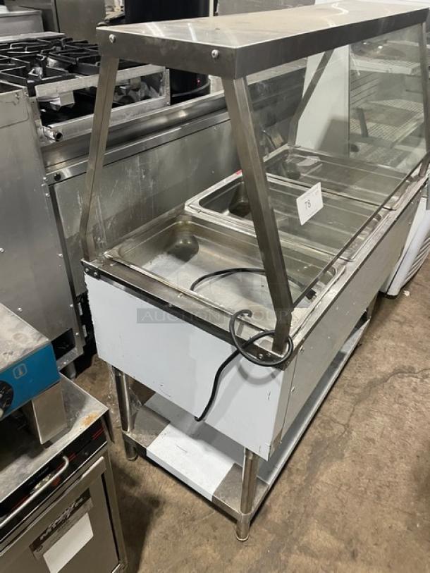 Serv-Ware EST3-1 stainless steel 3-well hot food steam table, with sneeze guard, single undershelf, electric, on legs.