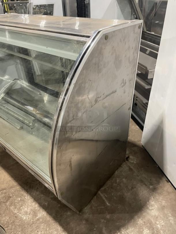 Leader 60" stainless steel deli merchandiser, model NRHD60SC, curved glass, double glass doors, lower storage, used condition.