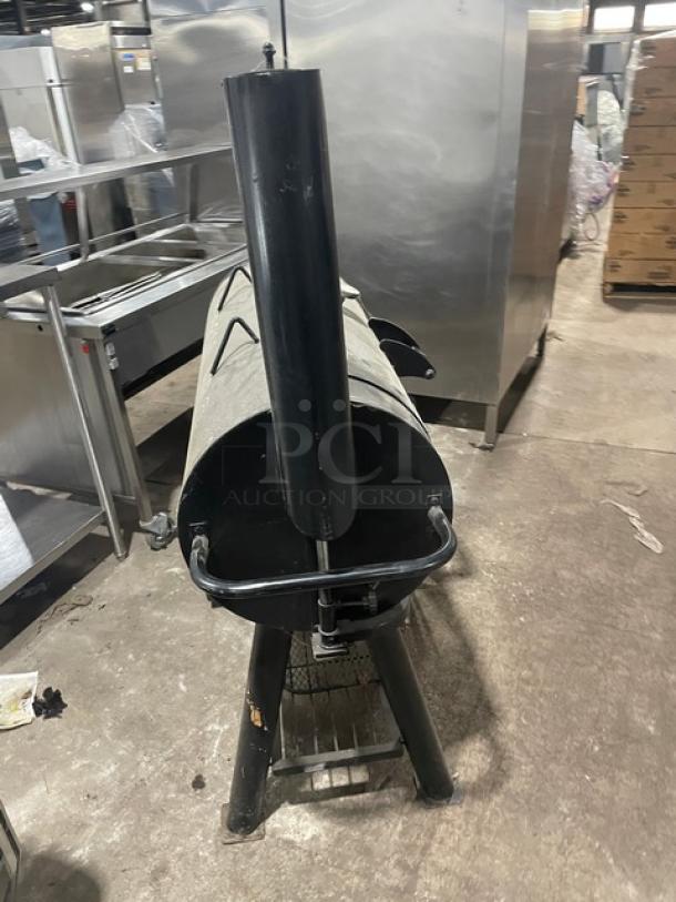 Brinkmann Professional Series black offset charcoal smoker/grill, features cylindrical design, sturdy build, used condition.