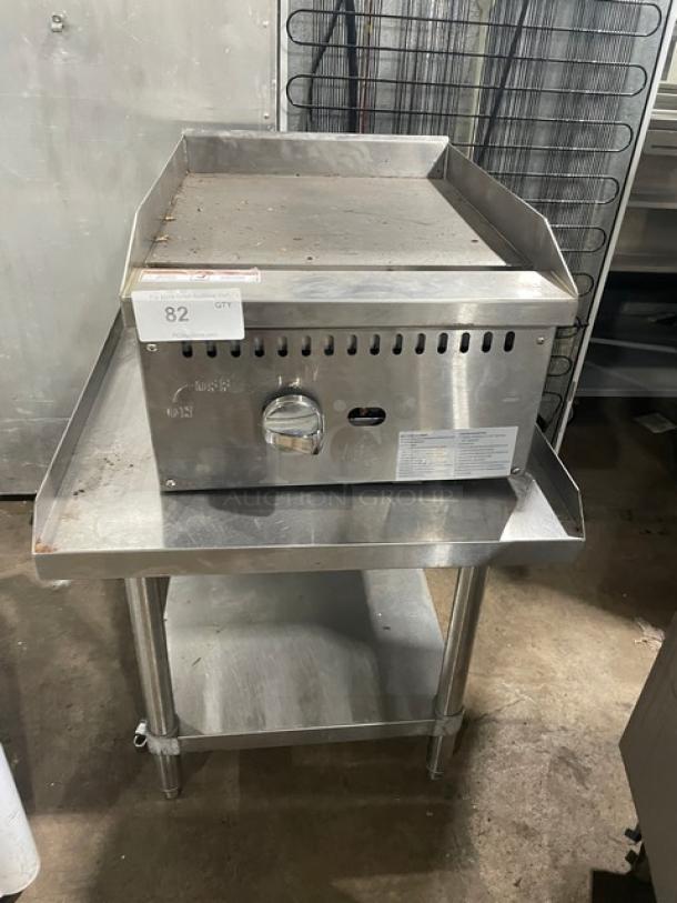 Adcraft ECTG16NG stainless steel gas griddle with splash guards on equipment stand. Includes control knob and label.