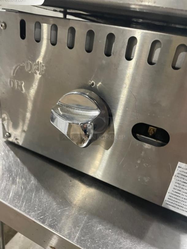 Adcraft ECTG16NG stainless steel countertop flat griddle with dial, featuring back and side splash. Natural gas powered.