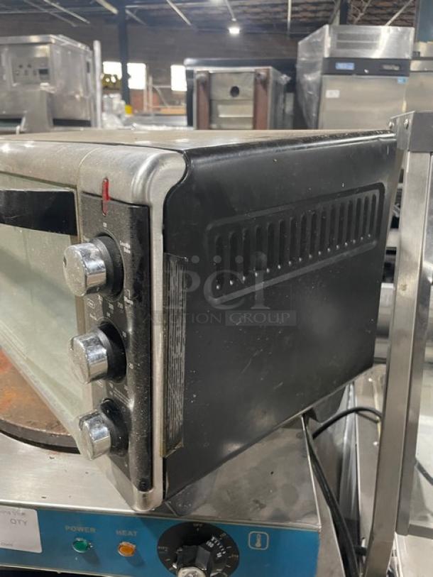 BLACK+DECKER TO3250XSB stainless steel convection toaster oven, extra wide, electric, with control knobs, model label visible.