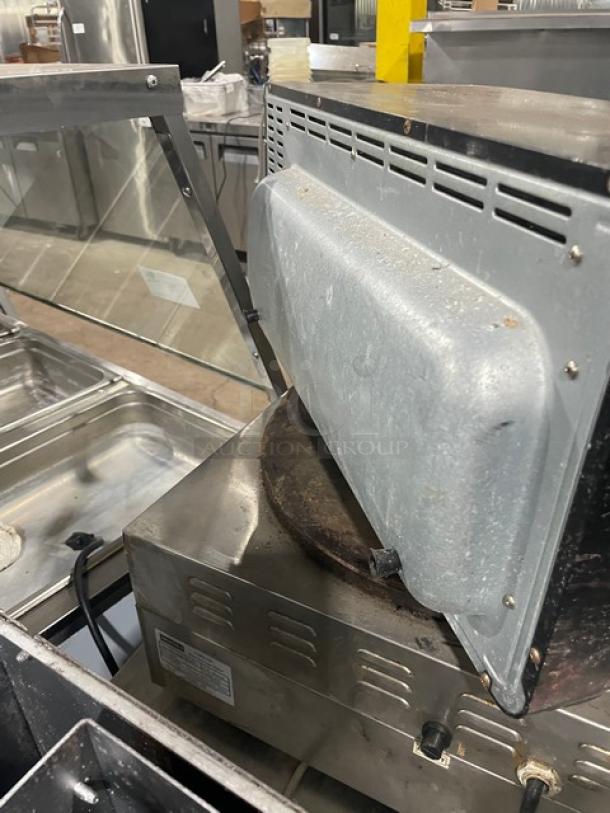BLACK+DECKER Model TO3250XSB stainless steel convection toaster oven, 120V, on legs. Shows signs of wear.