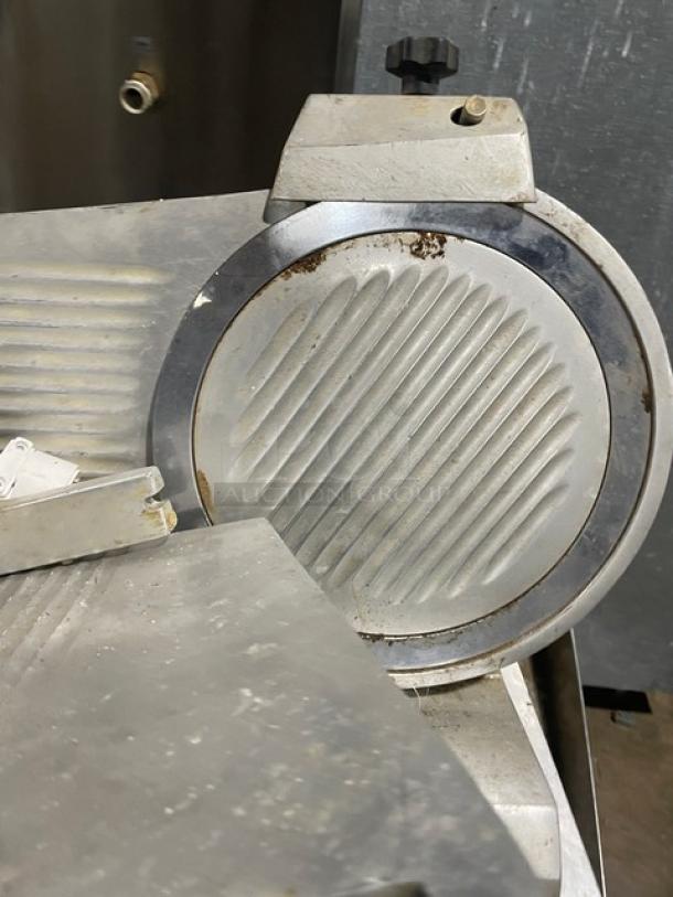 Univex Duro Series commercial deli meat slicer, electric, countertop model, on legs, visible wear and rust, metallic finish.