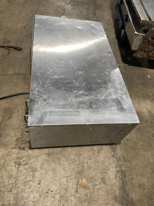 Star commercial stainless steel single warming drawer, electric-powered, free-standing, visible wear, functional.