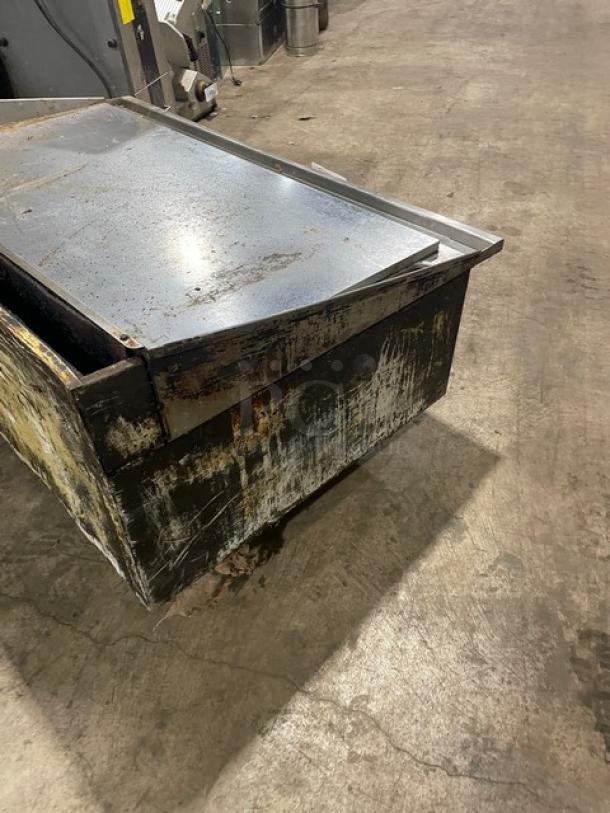 Commercial stainless steel natural gas countertop flat griddle with back and side splash, on legs, pre-owned condition.